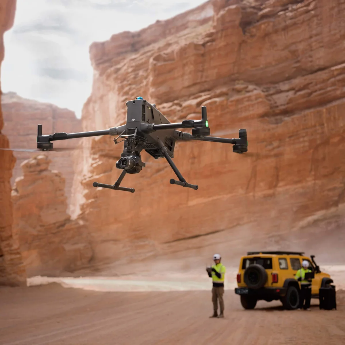 Professional drone flying near mountains and rocky landscape